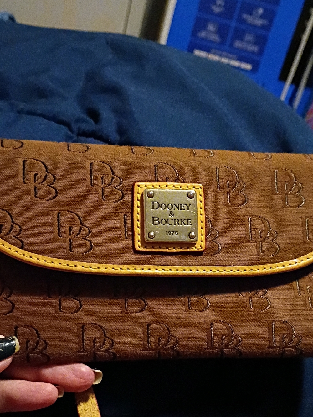 Dooney & Bourke Brown Clutch with Yellow Trim and Logo Plaque